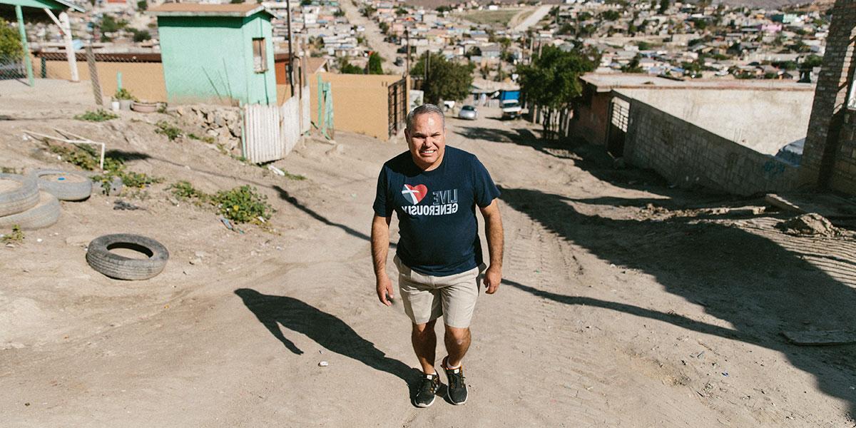 Ramon walking through a neighborhood in Mexico